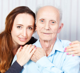 senior man and grand daughter smiling